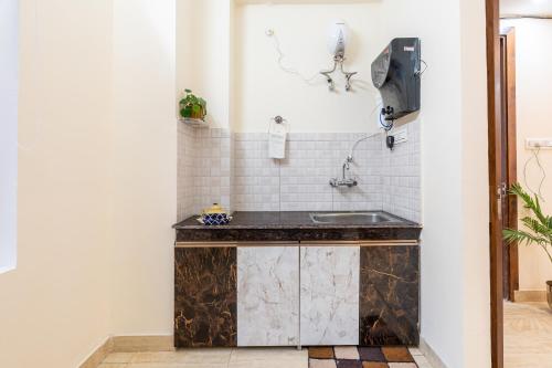 a bathroom with a counter with a sink at Homlee - Hill View Apartment Luxury in Rishīkesh