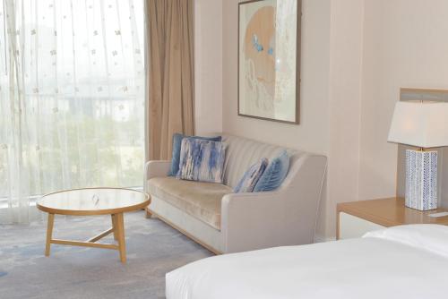 a living room with a couch and a table at Le Meridien Suzhou, Suzhou Bay in Suzhou