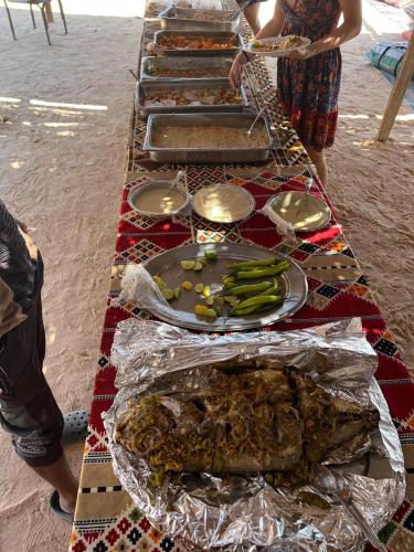 a table with many different types of food on it at Blend in Nature Eco Camp Beachfront Stay in Ras Mohamed, Sharm El Sheikh in Sharm El Sheikh