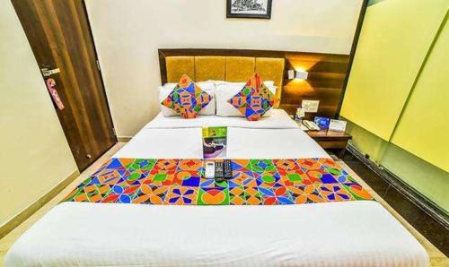 a hotel room with two beds with colorful tiles on them at FabHotel Ascot International II in Mumbai