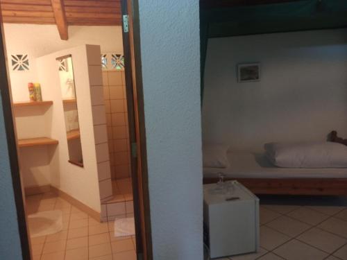 a small bedroom with a bed and a small table at Dik Dik Hotel in Arusha
