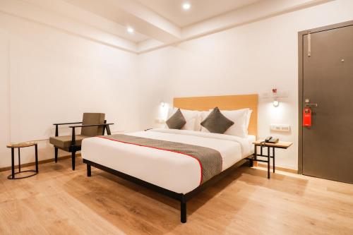 a bedroom with a large bed and a desk at Townhouse South Tukoganj in Indore