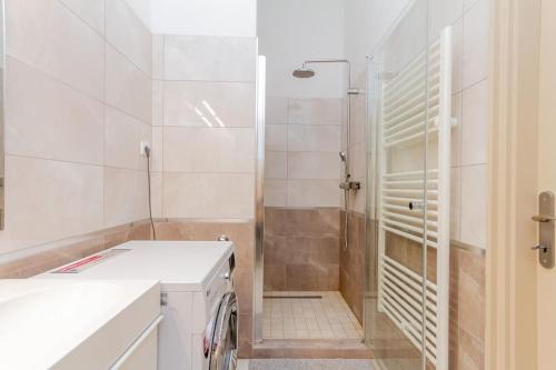 a bathroom with a shower with a glass door at Bartók Boulevard Apartment by NW in Budapest