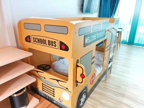 a toy school bus bunk bed in a room at Southern Airport Hotel Hatyai in Hat Yai