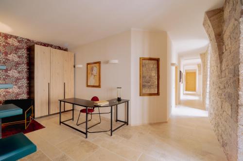 a living room with a table and a chair at Benedictine monastery of 1072 in Assisi
