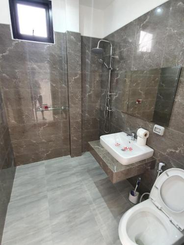 a bathroom with a sink and a shower and a toilet at duplex 2 bedroom sea view villa with private pool in Koh Samui