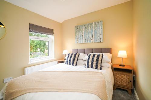 a bedroom with a bed and a window at Rural escape with peaks from your door in Sheffield