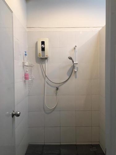 a bathroom with a shower with a shower head at Zee Thai Hostel in Bangkok