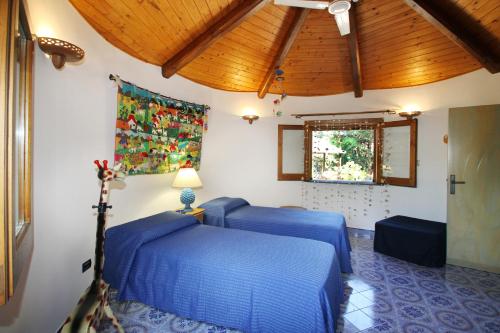 3 camas azules en una habitación con techo en BOUTIQUE VILLA con accesso privato alla spiaggia en Caronia
