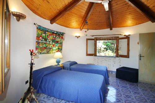three blue beds in a room with a ceiling at BOUTIQUE VILLA con accesso privato alla spiaggia in Caronia