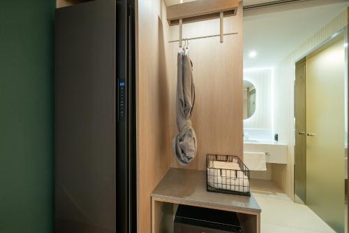 a small bathroom with a counter and a sink at Hound Hotel Gimhae Samgye in Gimhae