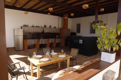 a room with a table and chairs and a kitchen at ROOM Micheli's Guest house Ivanovka in İvanovka