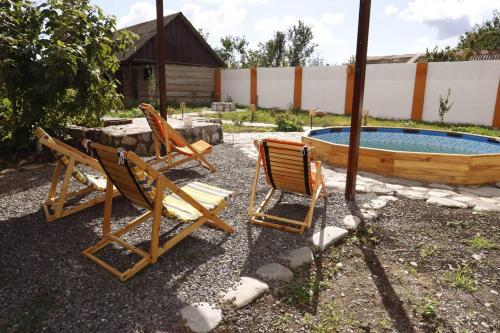 a group of chairs sitting next to a swimming pool at ROOM Micheli's Guest house Ivanovka in İvanovka