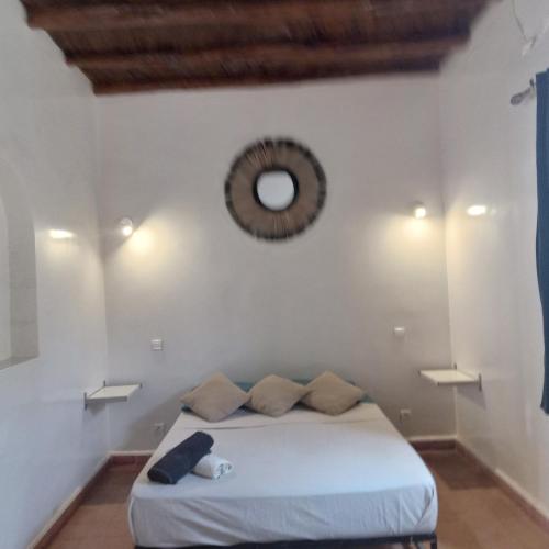 a bedroom with a bed and a mirror on the wall at Villa Mogador in Essaouira