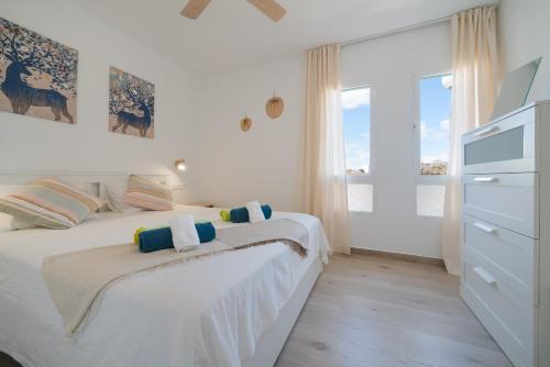 a white bedroom with a bed and a window at Lanzahost Carmenes Comfort in Costa Teguise