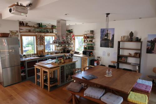 a kitchen with a table and a refrigerator and a table at Maison d'architecte avec vue sur Sens in Paron