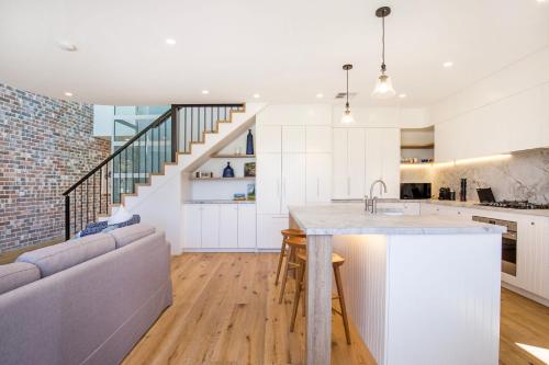 an open kitchen and living room with a couch at Camellia - Pet Friendly - 3 Min Walk to Centre of Berry in Berry