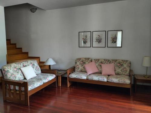 a living room with two chairs and a couch at Vista mozzafiato sulle Dolomiti Friulane in Forni di Sopra
