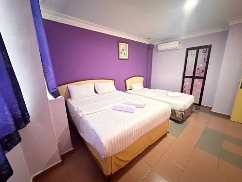 Postelja oz. postelje v sobi nastanitve Hotel Sri Muda Corner Sdn Bhd