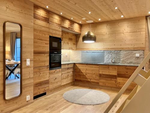 a kitchen with wood paneled walls and a mirror at VILLA TUNDRA in Ruka