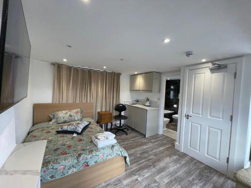 a bedroom with a bed and a bathroom at Luxury Rooms with En-suite bathrooms - West London in Harrow on the Hill