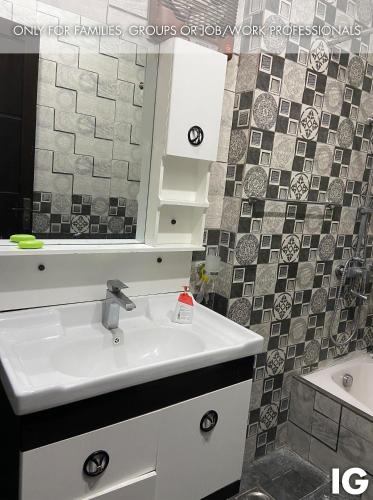 a bathroom with a sink and a mirror at Spacious 3 Bedroom Furnished Family Home near Valencia Town, Lake City & Ring Road in Lahore