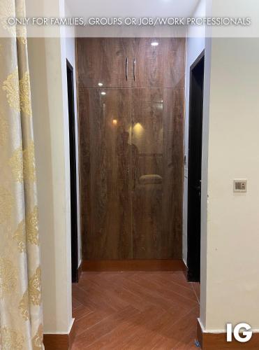 a hallway with a glass door in a room at Spacious 3 Bedroom Furnished Family Home near Valencia Town, Lake City & Ring Road in Lahore