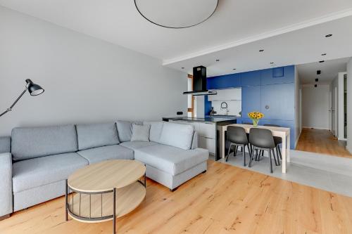 a living room with a couch and a table at Staywin Apartments in Gdańsk