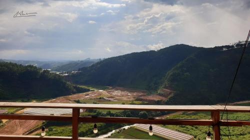 an airplane is flying over a valley with mountains at Tuyên Chiến Home - Nhà Gỗ in Ấp An Kroët