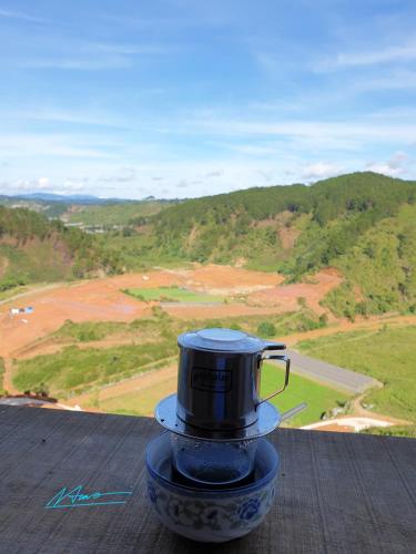 a coffee pot sitting on top of a table at Tuyên Chiến Home - Nhà Gỗ in Ấp An Kroët