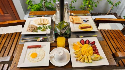 three plates of food on a table with breakfast foods at Dhonfalhu Dhigurah in Dhigurah