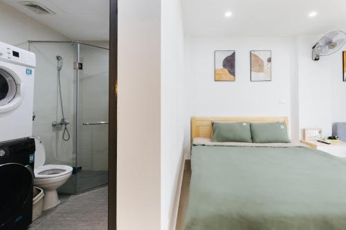 two views of a bathroom with a toilet and a shower at 9 LIGHT APARTMENT in Hanoi