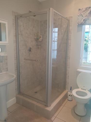 a shower stall in a bathroom with a toilet at Northlands Manor in Durban