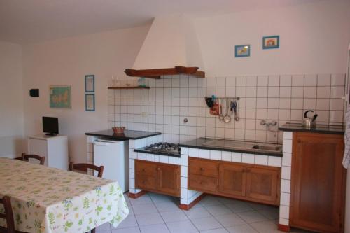 a kitchen with a sink and a stove top oven at Azienda Agricola Sapereta in Porto Azzurro