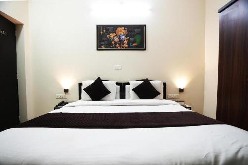 a bedroom with a large white bed in a room at Hotel Lotus Inn near Udaipur City Railway Station in Udaipur