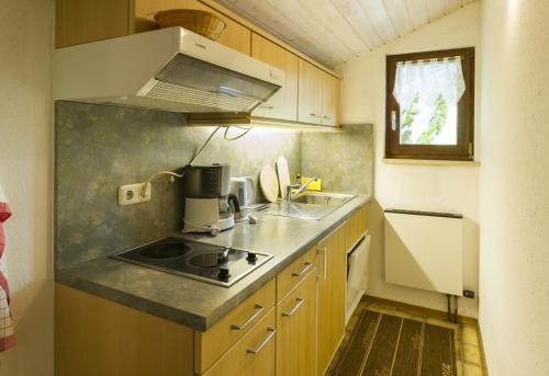a small kitchen with a sink and a stove at Villa Valluga in Mittelberg