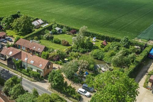 an aerial view of a house with a yard at Olde Farm Holiday Cottages in Banham