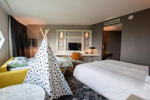 a hotel room with two beds and a christmas tree at Hilton Amsterdam Airport Schiphol in Schiphol