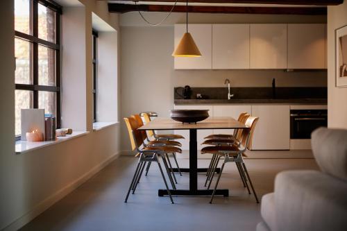 a kitchen with a wooden table and chairs at Hotel Miss Blanche in Groningen
