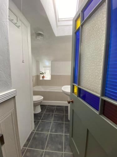 a bathroom with a toilet and a sink at Seaside Georgian gem in Combe Martin