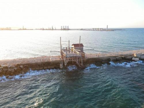 a dock in the middle of a body of water at CD Romanello (Mura S. Cataldo) in Barletta