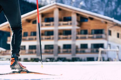 a person on skis in front of a building at Wagner's Aparthotel in Pertisau