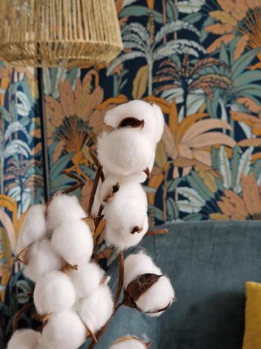 a bunch of white cotton hanging from a wall at Le Cottage in Quimper