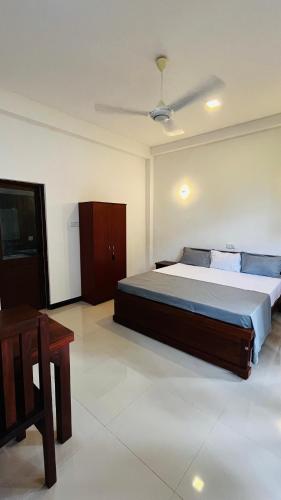 a bedroom with a large bed in a room at New Stay Inn in Bentota