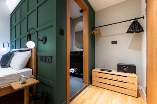 a room with a bed and a green door at Habyt Cantonment - formerly Hmlet Cantonment in Singapore