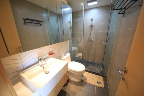 a bathroom with a sink and a toilet and a shower at Colorful Yunnan Absolutely Beautiful Dian B&B in Kunming