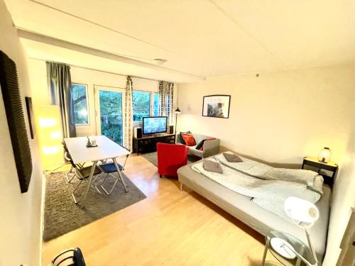 a bedroom with a bed and a living room at Whole Apartment 20 minutes from the city center in Søborg