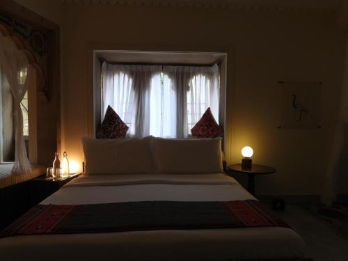 a bedroom with a large bed with a window at The Stepwell Hotel in Jodhpur