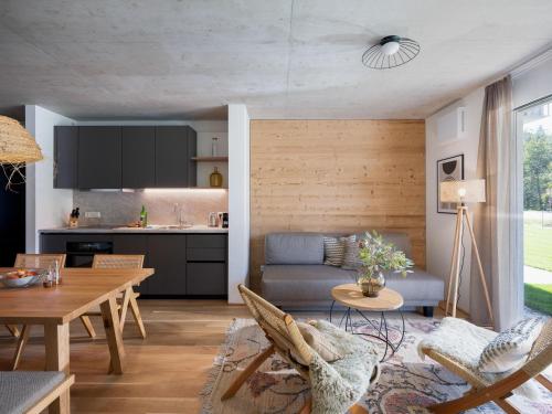 a kitchen and a living room with a table at BASECAMP Reiteralm in Pichl