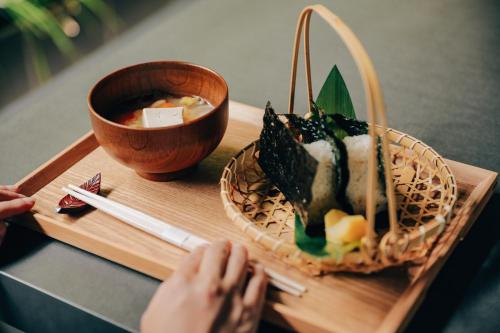 a table with a plate of food and a bowl of soup at KAMAKURA Hotel in Kamakura